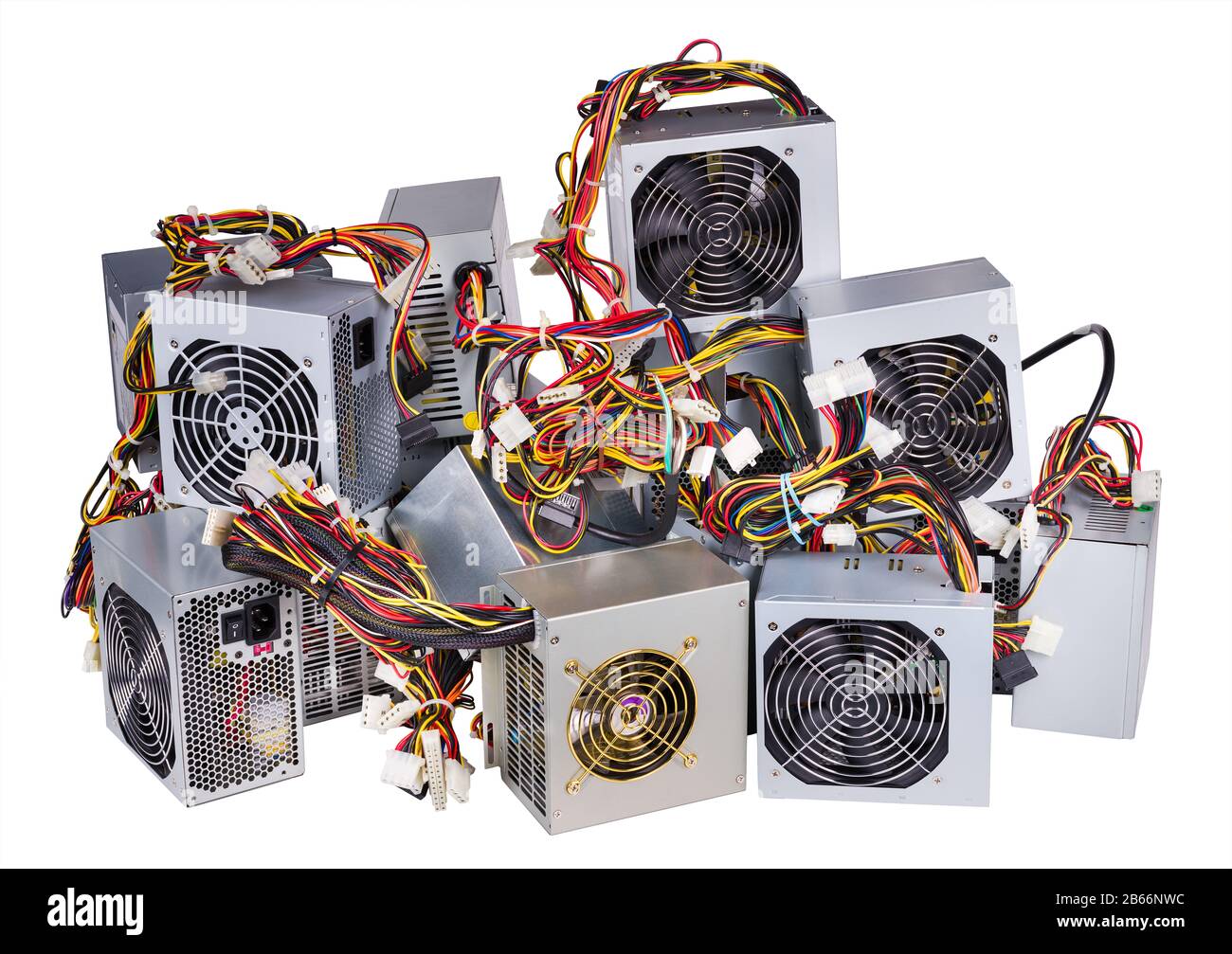 Group of computer power supply units. Pile of hardware spare parts. Square metal boxes with fans, electronic components and colorful cables. E-waste. Stock Photo