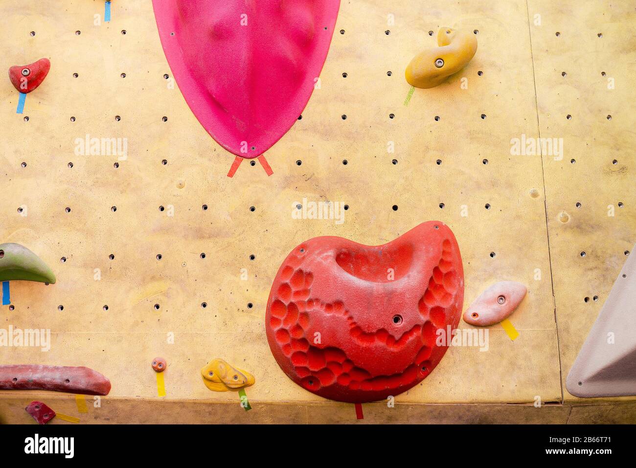climbing wall at modern gym with colored various hooks Stock Photo