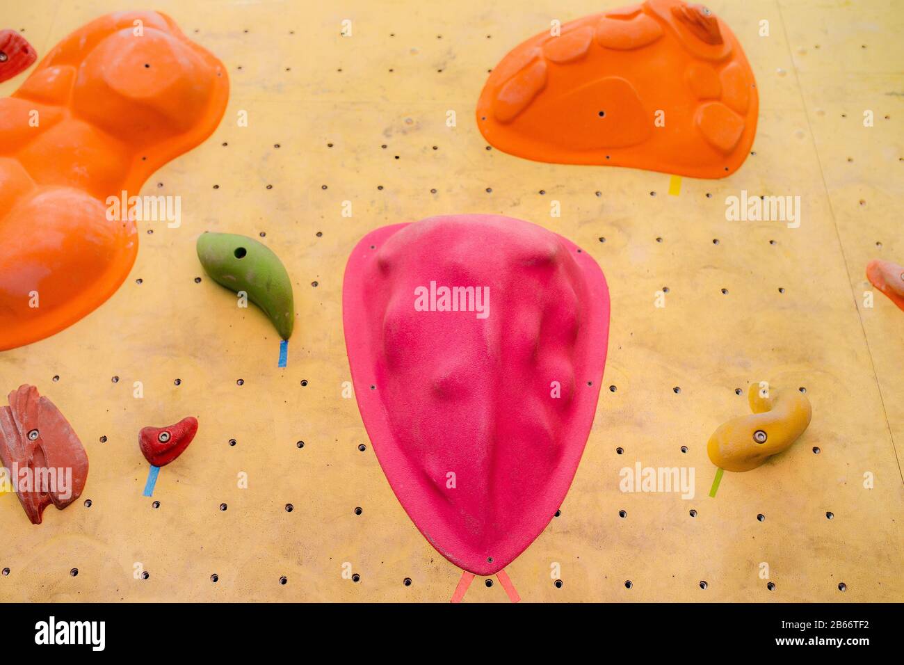 climbing wall at modern gym with colored various hooks Stock Photo