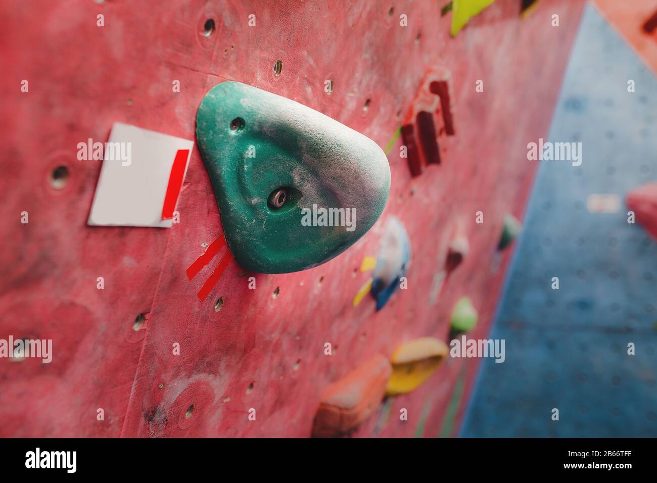 climbing wall at modern gym with colored various hooks Stock Photo