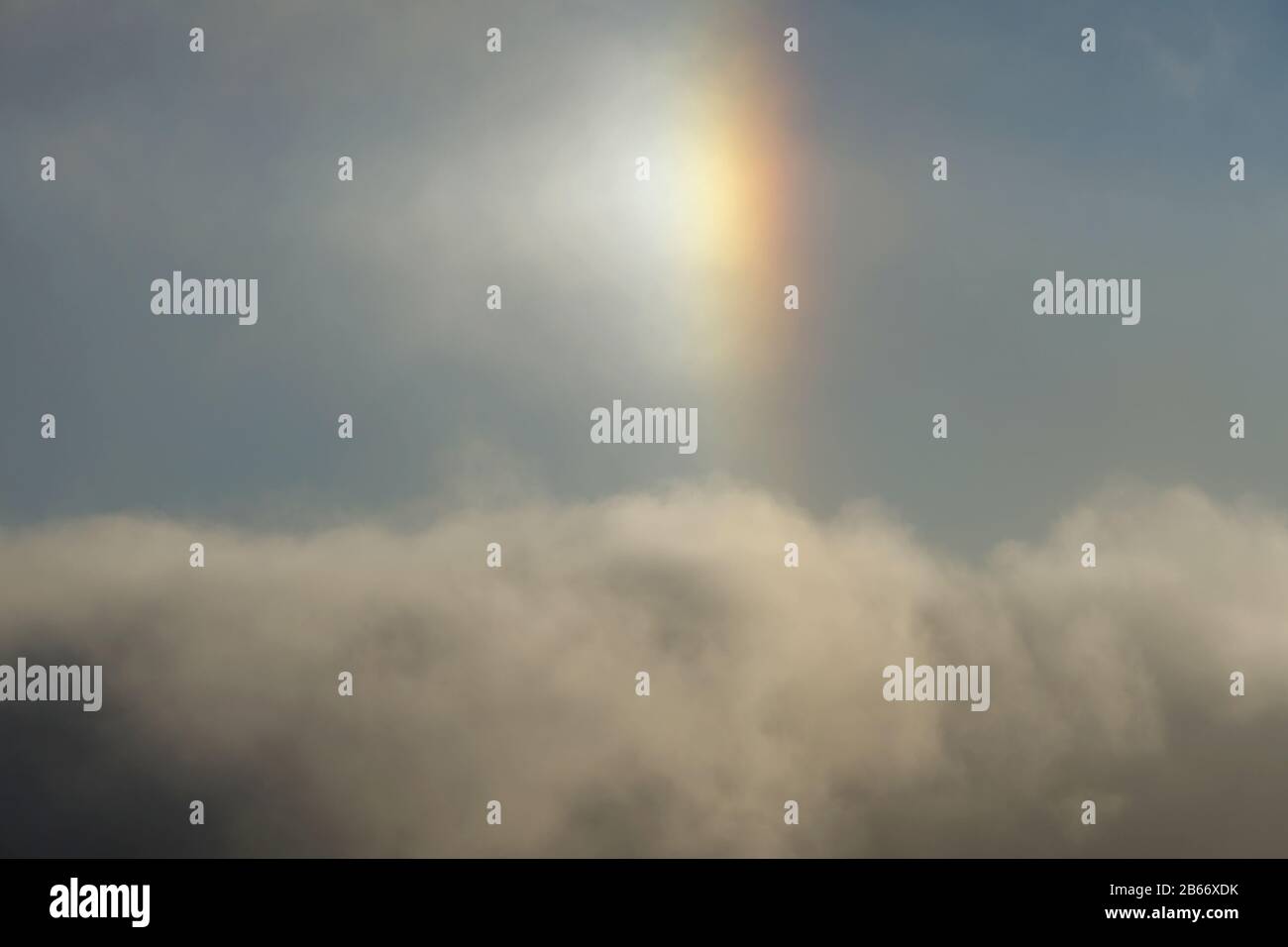 View of small rainbow called sun dog effect over the clouds in the sky