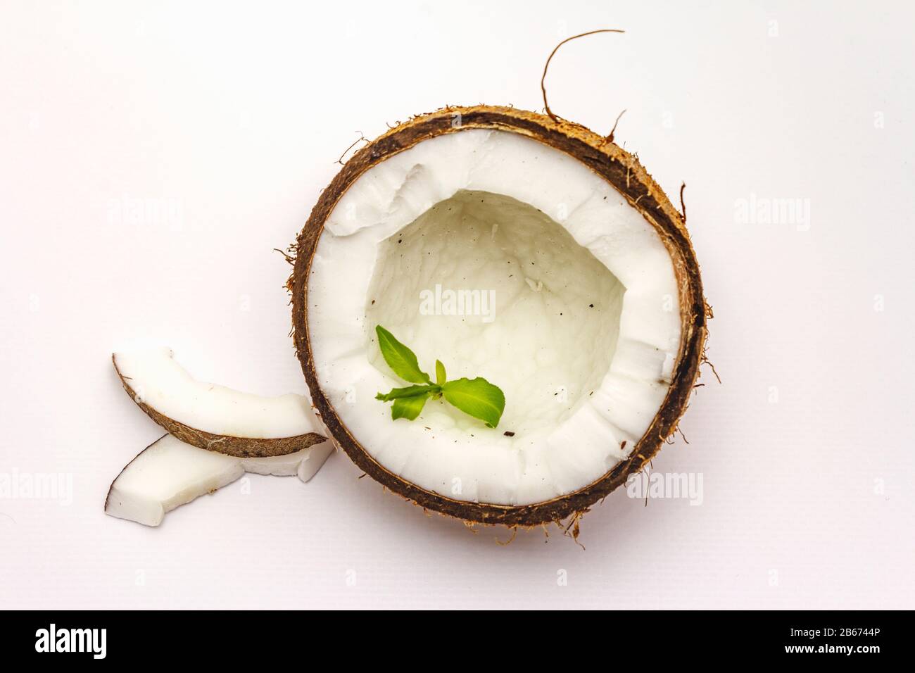 Ripe coconut cut on two half isolated on white background. Fresh fruit ...