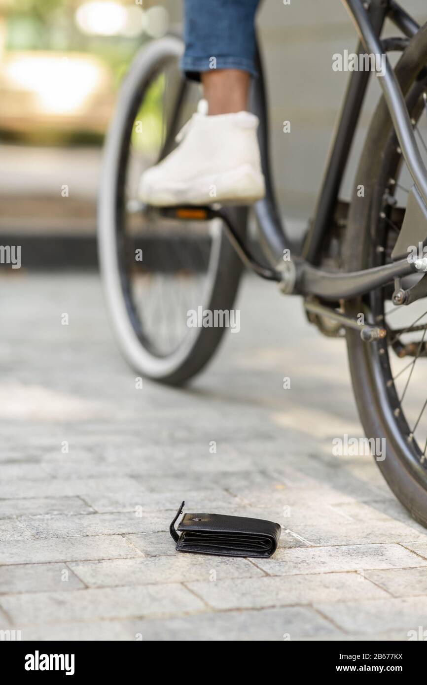 Daylife Troubles. Man Lost His Wallet While Riding Bike Outdoors Stock Photo