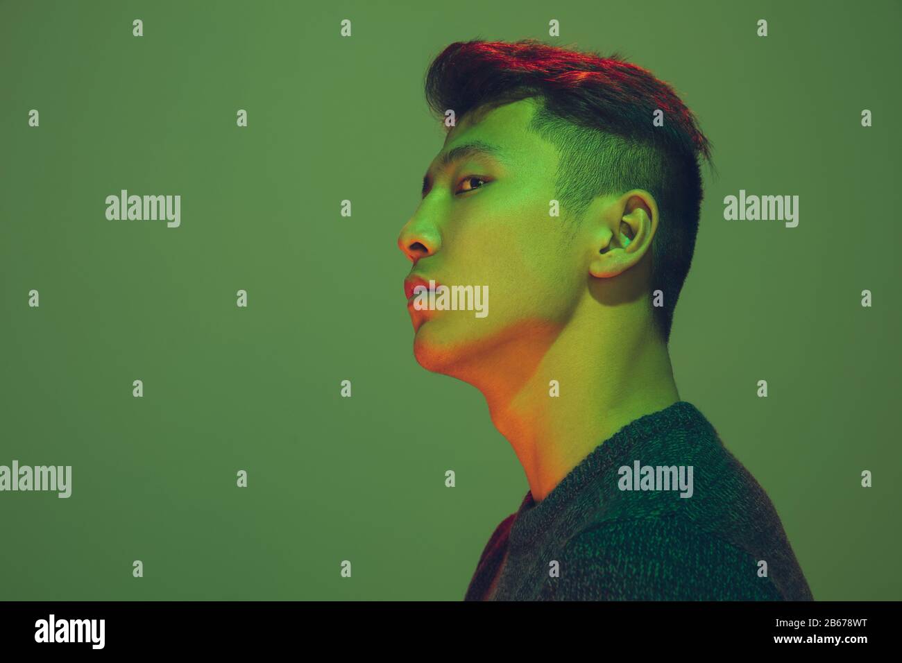 Portrait of a men in a futuristic cyberpunk style in neon clothes. A high-tech man
