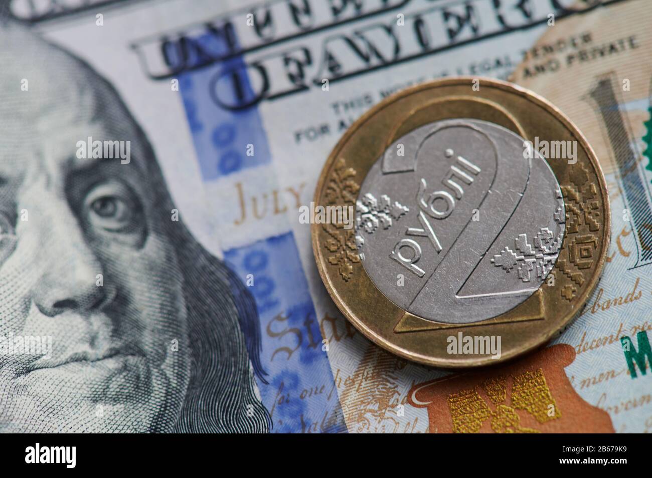 Belarusian coin on dollar banknote bill close up view Stock Photo