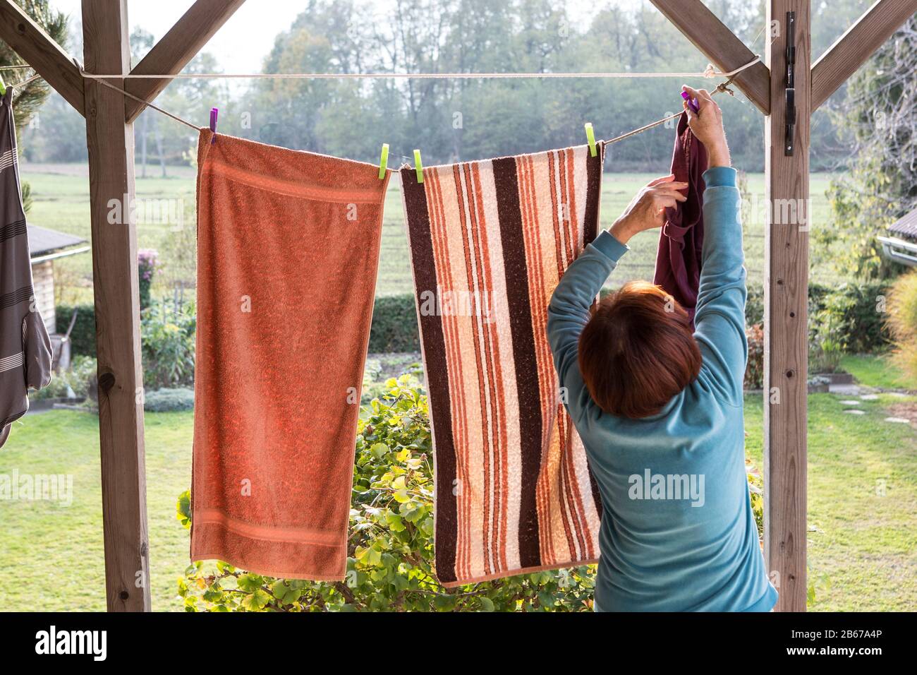linen towels weighs outside and dry on a rope Stock Photo Alamy