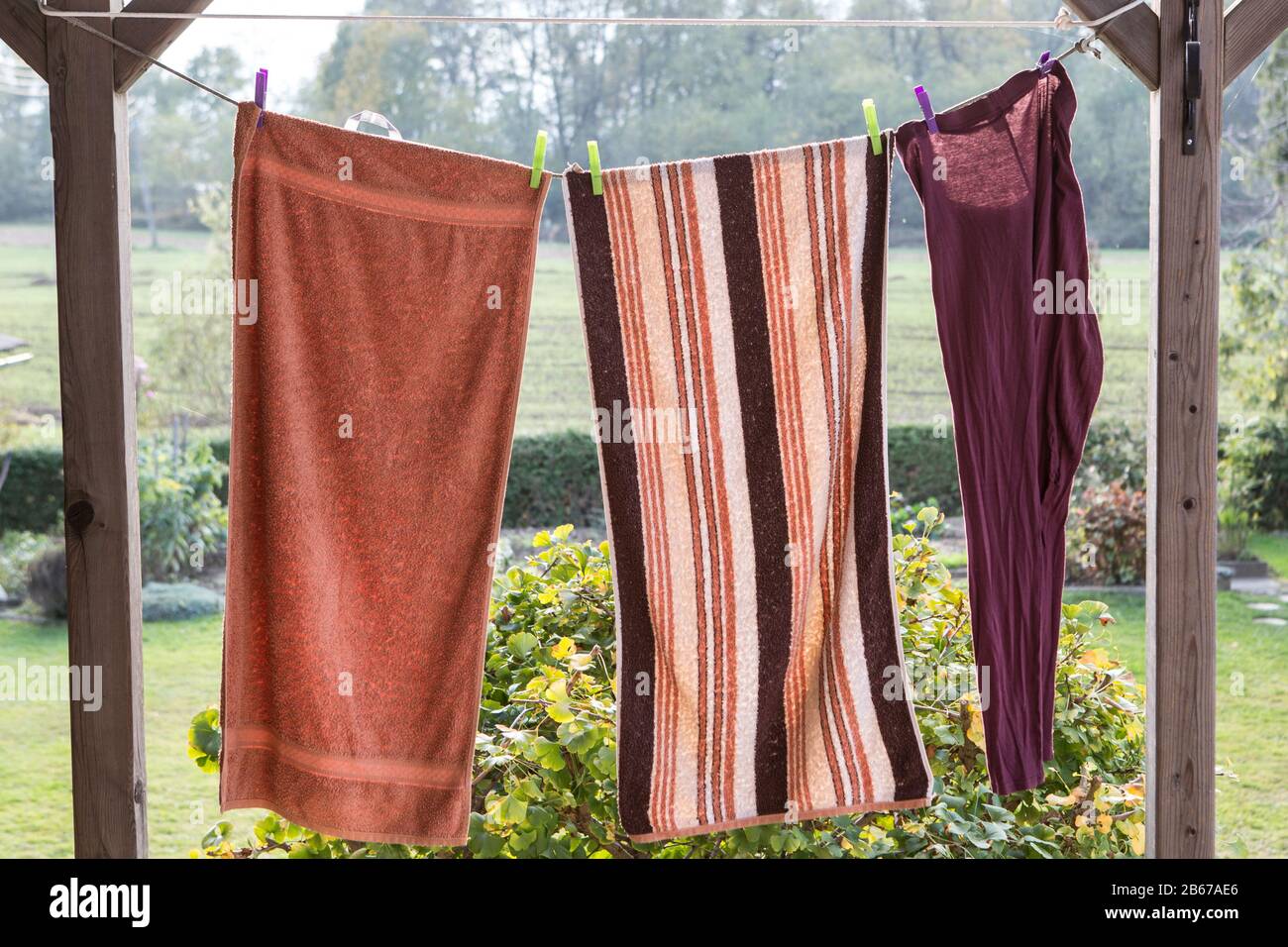linen towels weighs outside and dry on a rope Stock Photo Alamy