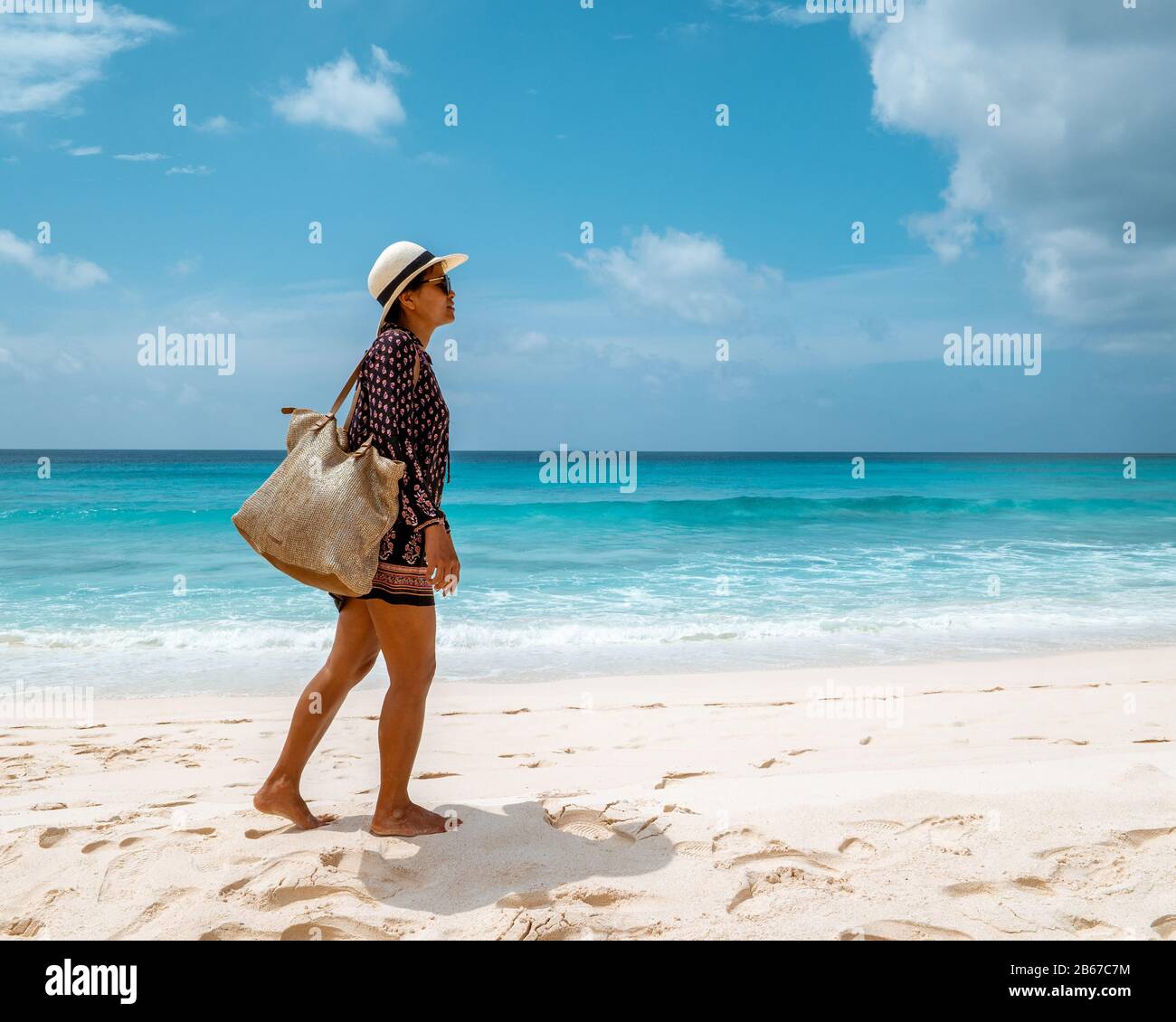 La Digue Seychelles,young woman in casual clothes on the beach at Anse