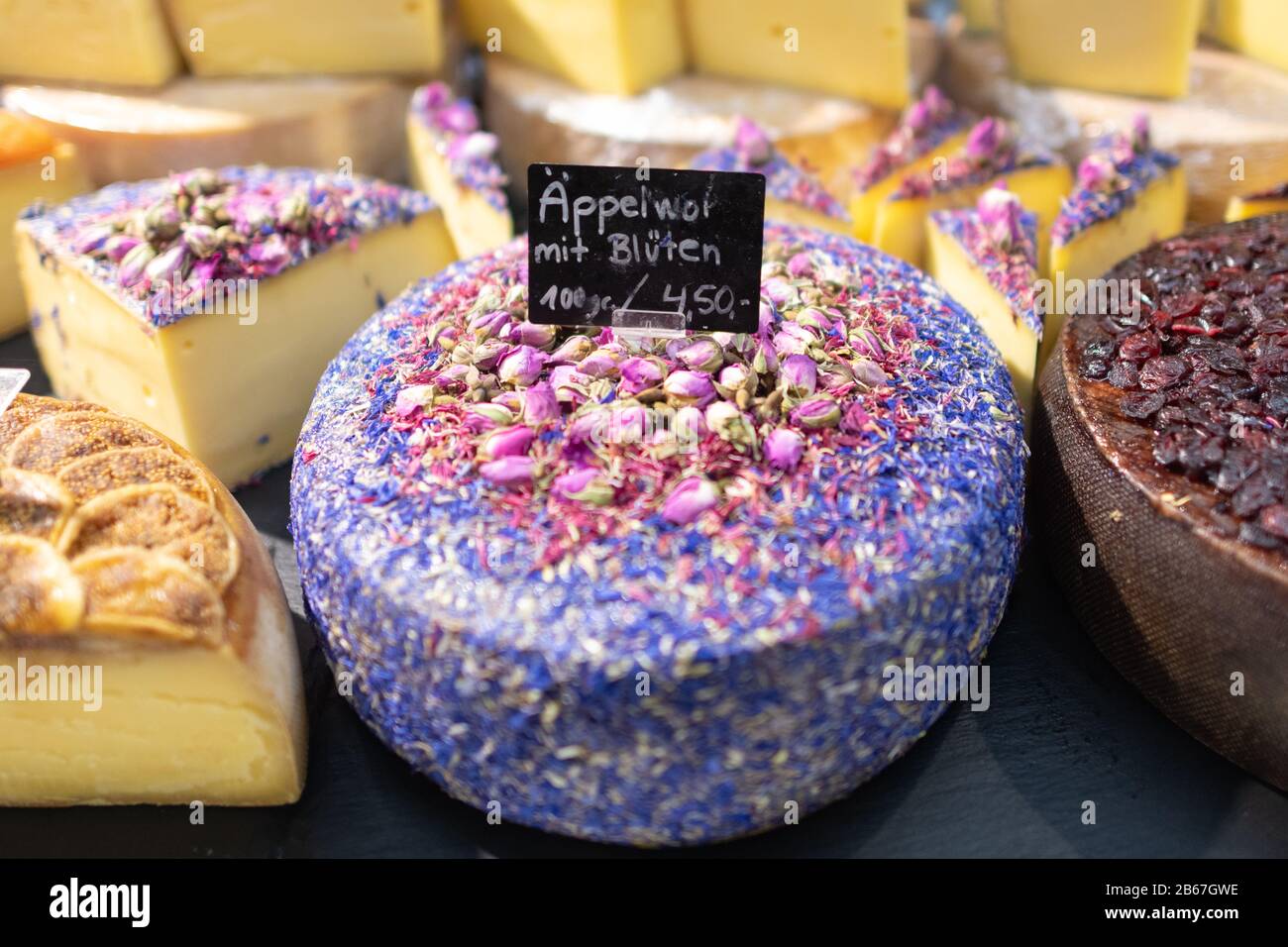 Apfelwein (Appelwoi) cheese decorated with cornflower petals and rose petals at Main Gourmet stand at Kleinmarkthalle, Frankfurt, Germany Stock Photo