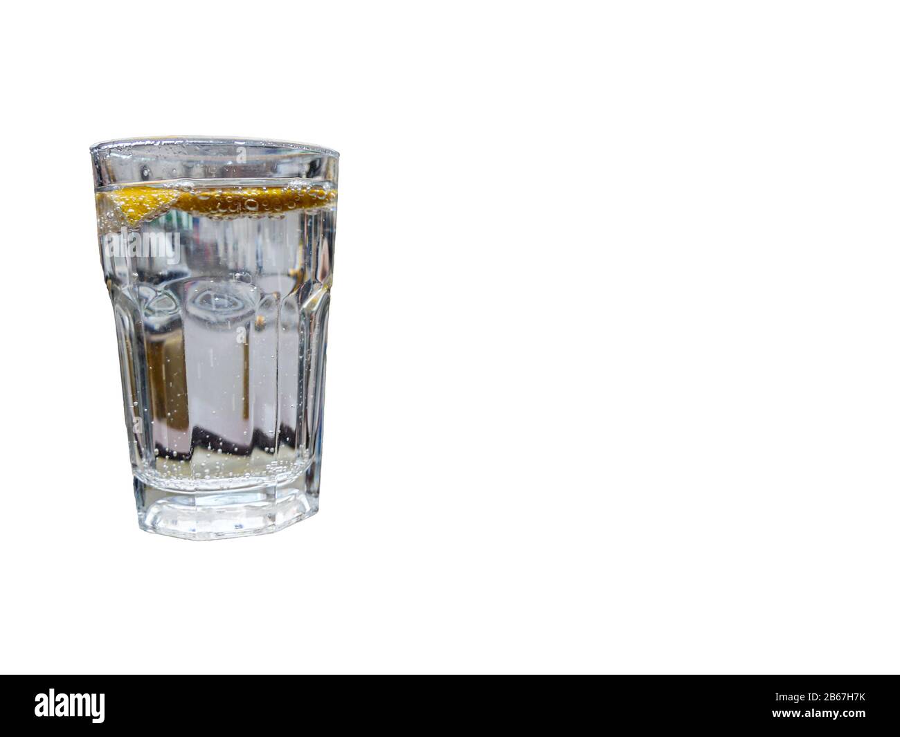 glass of sparkling water with lemon slices isolated on white. drink and refreshment concept Stock Photo