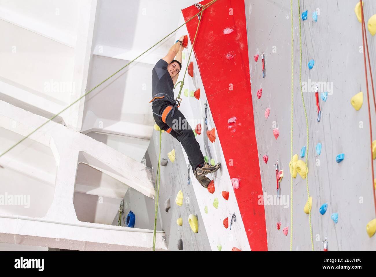 Man climbing indoor wall hi-res stock photography and images - Alamy