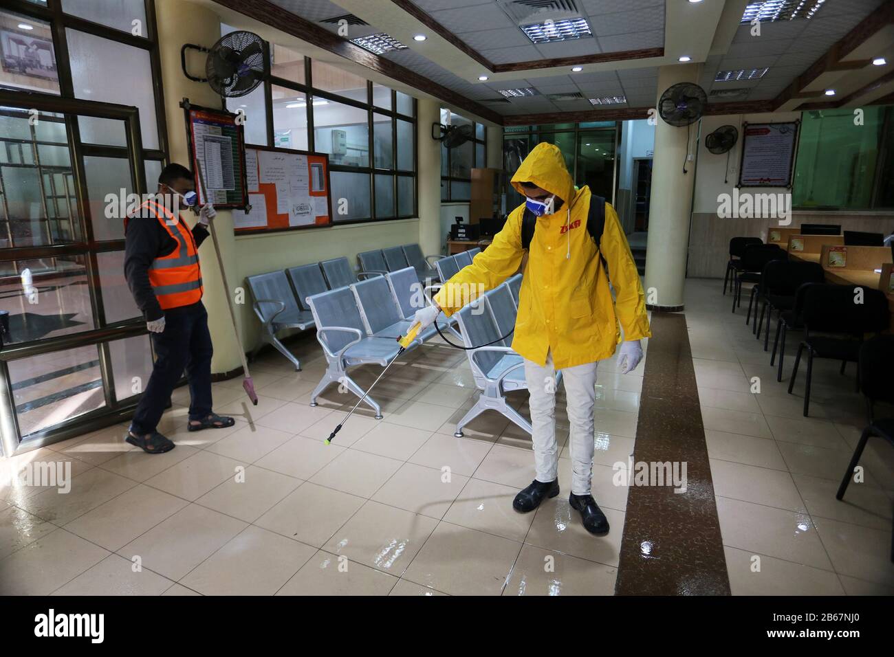 Palestinian workers disinfect a municipal building, in Gaza, as a preventive measure amid fears over the spread of new coronavirus, on March 9, 2020. Stock Photo
