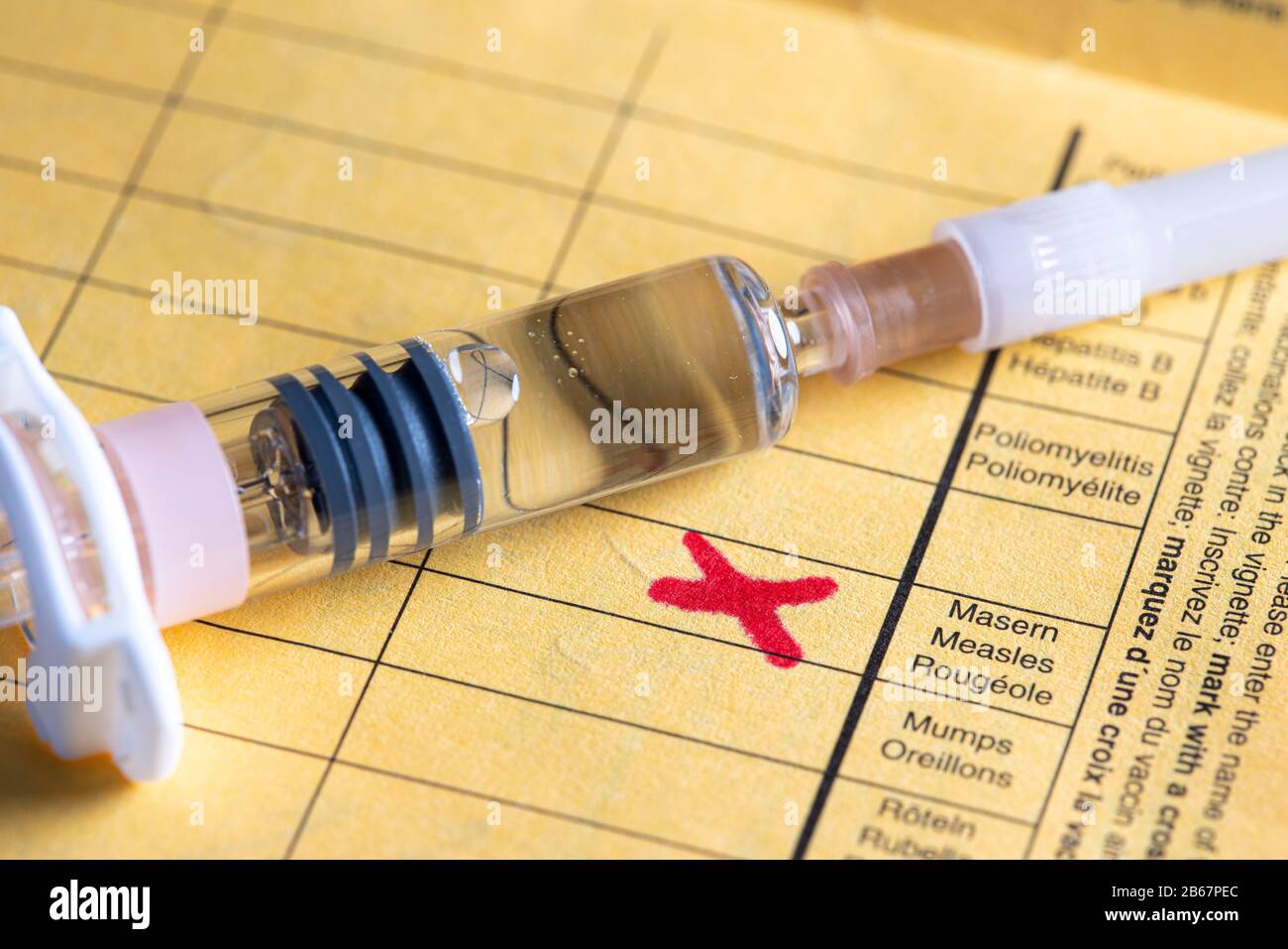 Measles vaccination, vaccination card,  syringe with measles vaccine, symbolic image, Stock Photo