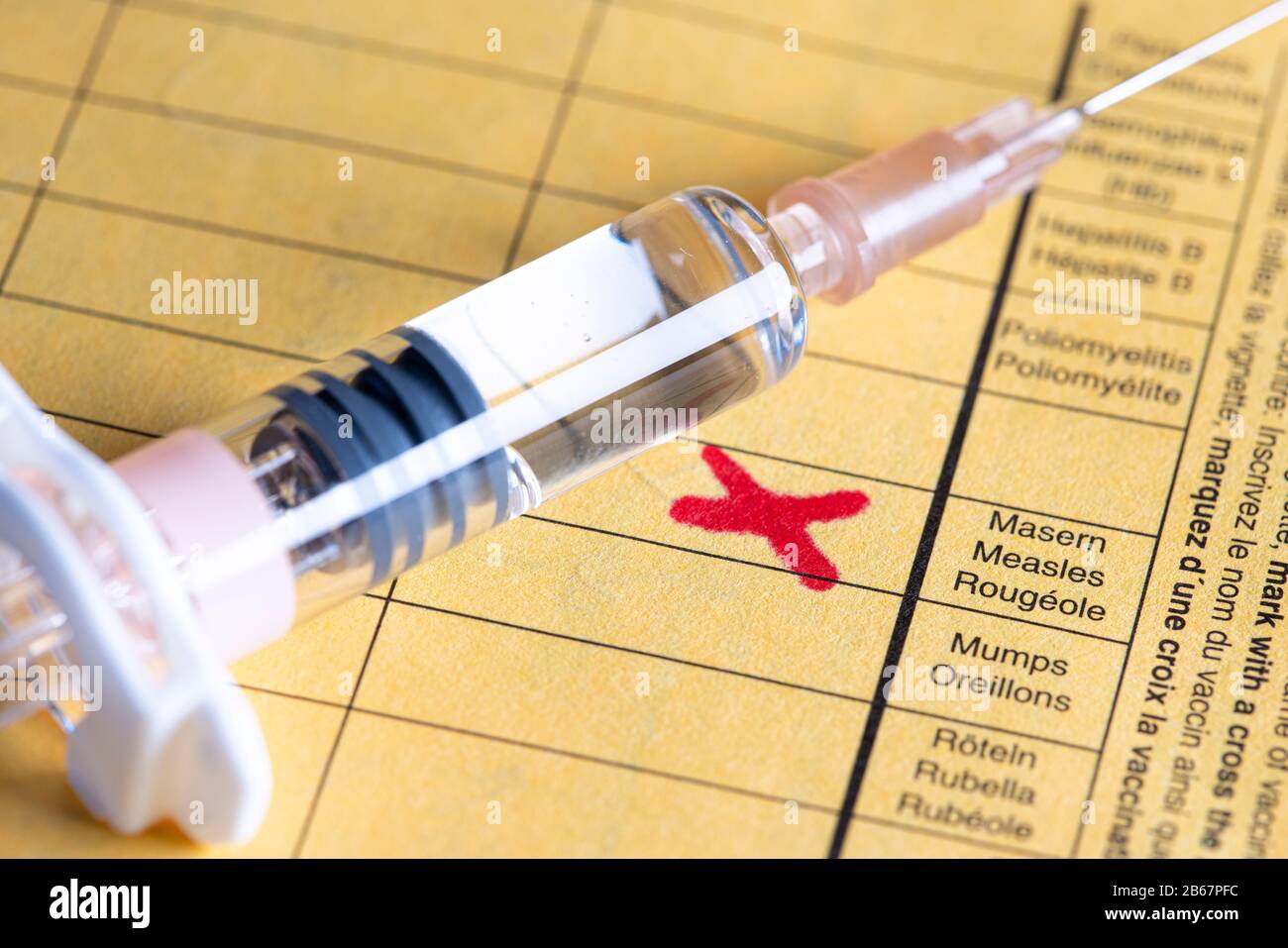 Measles vaccination, vaccination card,  syringe with measles vaccine, symbolic image, Stock Photo
