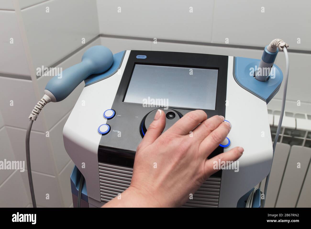 Medical Ultrasound therapy device with the hand of medical worker as  operator setting the apparatus Stock Photo - Alamy
