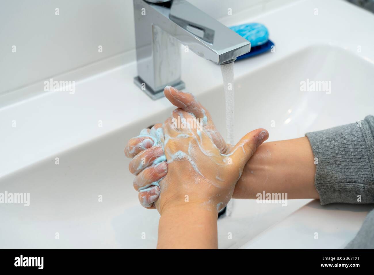 Domestic hygiene, wash hands with a bar of soap, boy 9 years old, Stock Photo