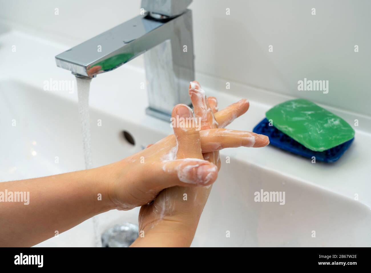 Domestic hygiene, wash hands with a bar of soap, boy 9 years old, Stock Photo