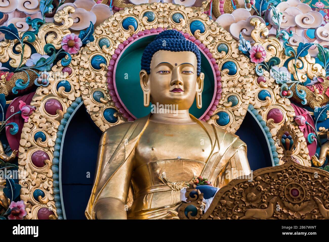 Gilded golden statue of Shakyamuni Buddha in a Tibetan temple in Dehradun district of Uttara Khand,India Stock Photo