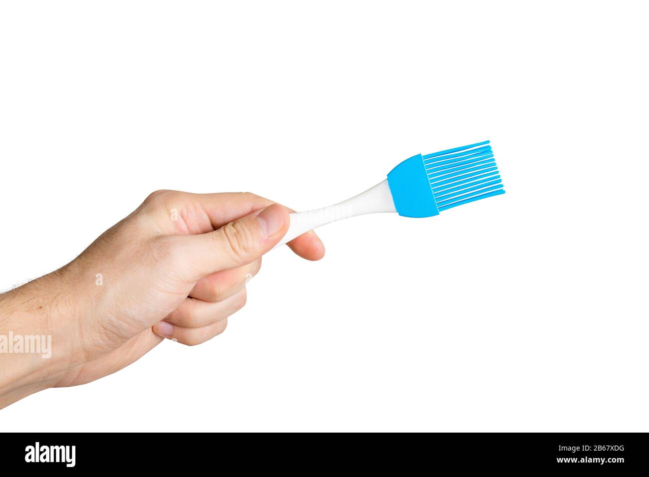 Hand with silicone cooking brush isolated Stock Photo