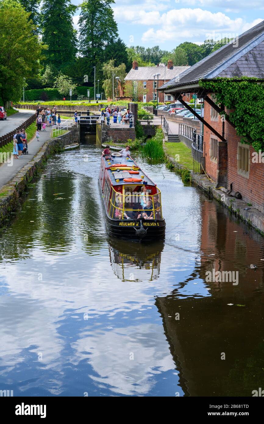 Visitors on a trip boat on the Montgomery Canal in Welshpool during the  Welshpool Transport Festival held in the town in Wales. Stock Photo
