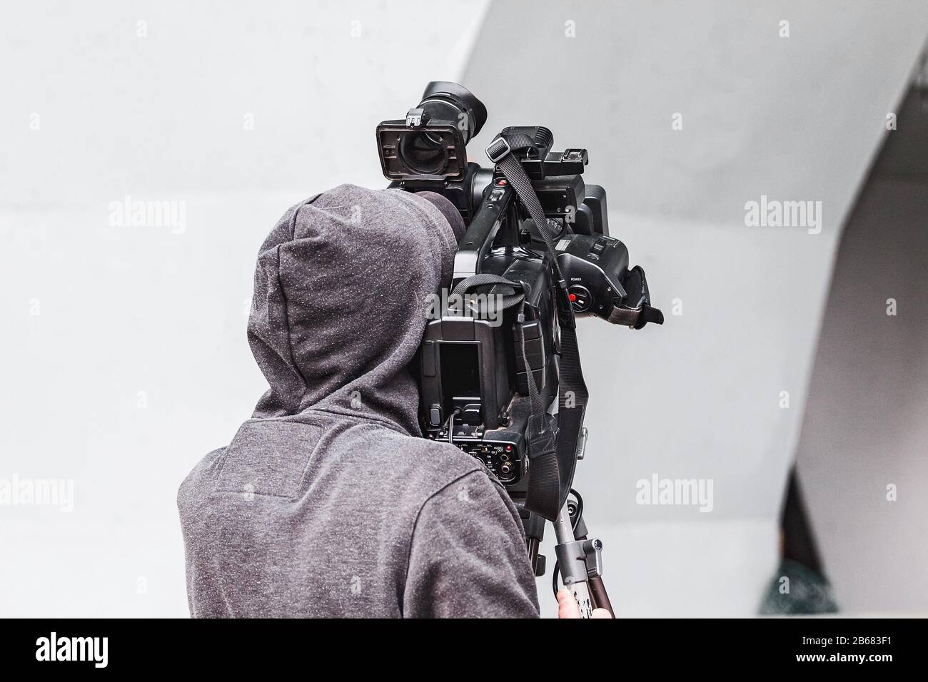 Back view of a professional TV camera man Stock Photo