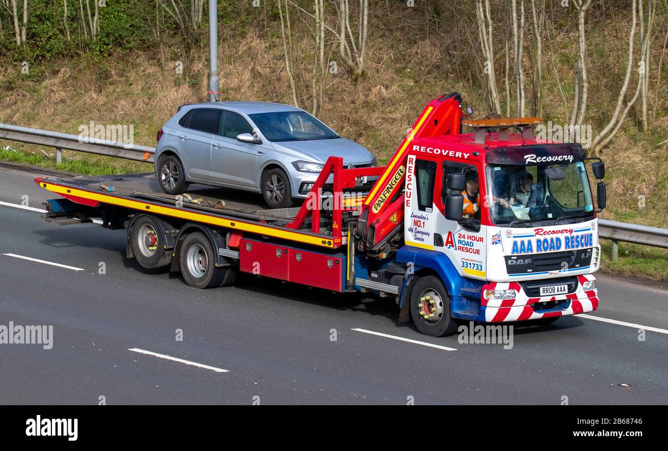 AAA, 24 hr accident and breakdown recovery services VW Volkswagen Road Rescue, 24-hour roadside breakdown service. Haulage delivery trucks, lorry, transportation, truck, AUTO carrier, DAF LF vehicle, European commercial transport, industry, M61 at Manchester, UK Stock Photo