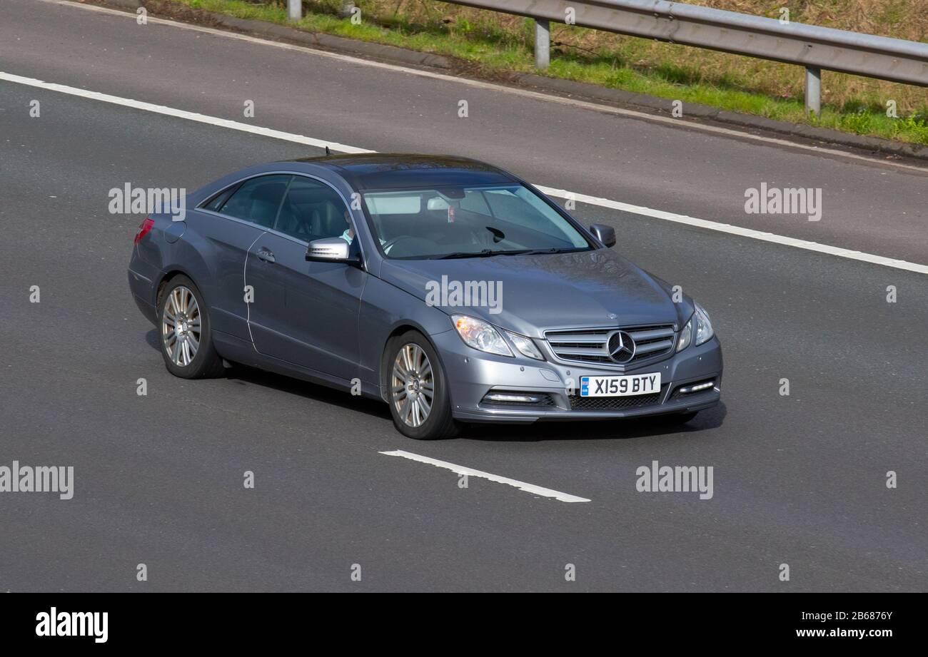 2013 SILVER GREY Mercedes-Benz Model E220 Se Cdi Blueeffic-Ncy; UK vehicular traffic, transport, modern vehicles, saloon cars, moving vehicles, vehicle, roads, motors, motoring  on the M6 motorway highway Stock Photo