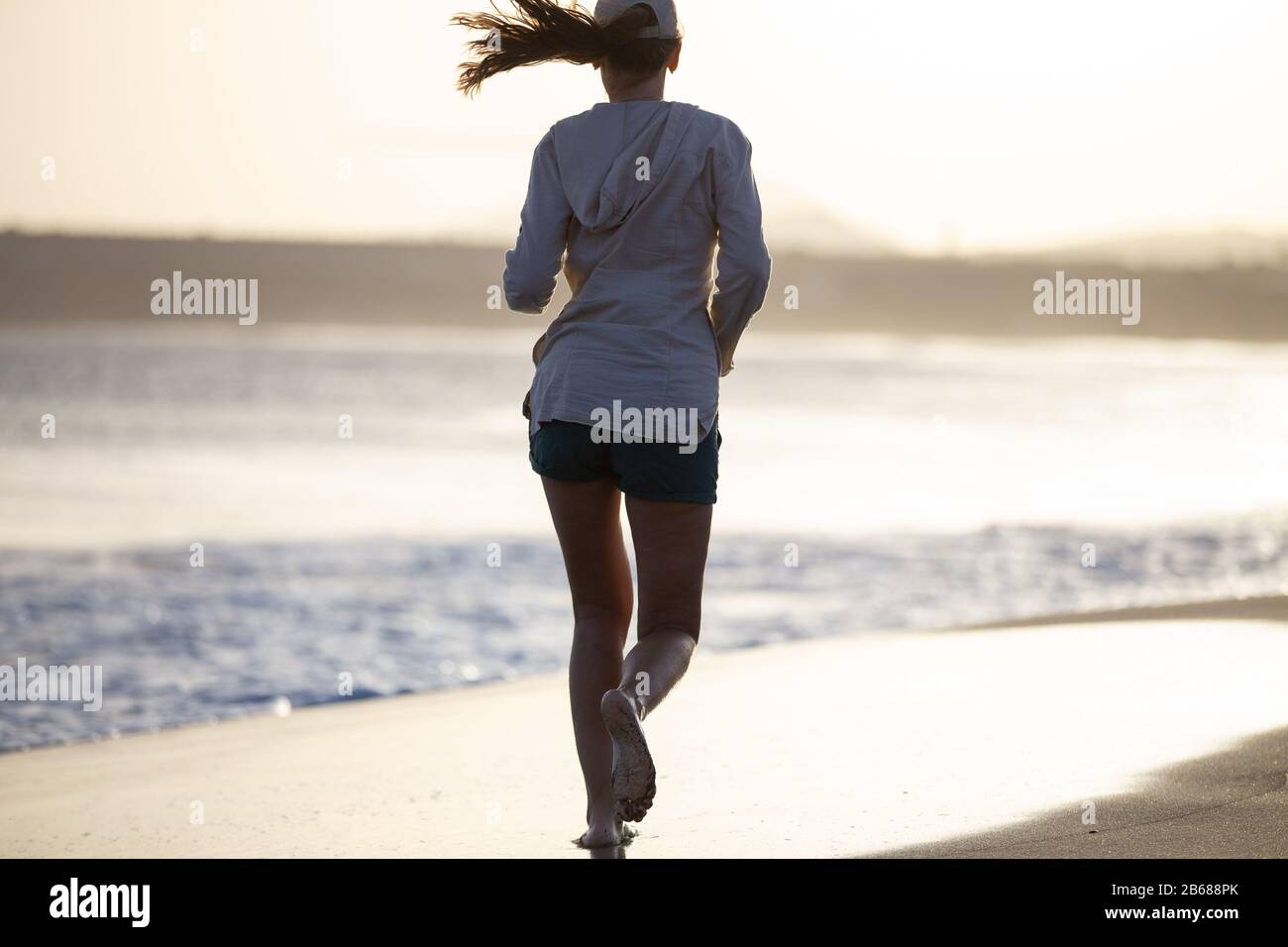 One woman running barefoot warm hi-res stock photography and images - Alamy