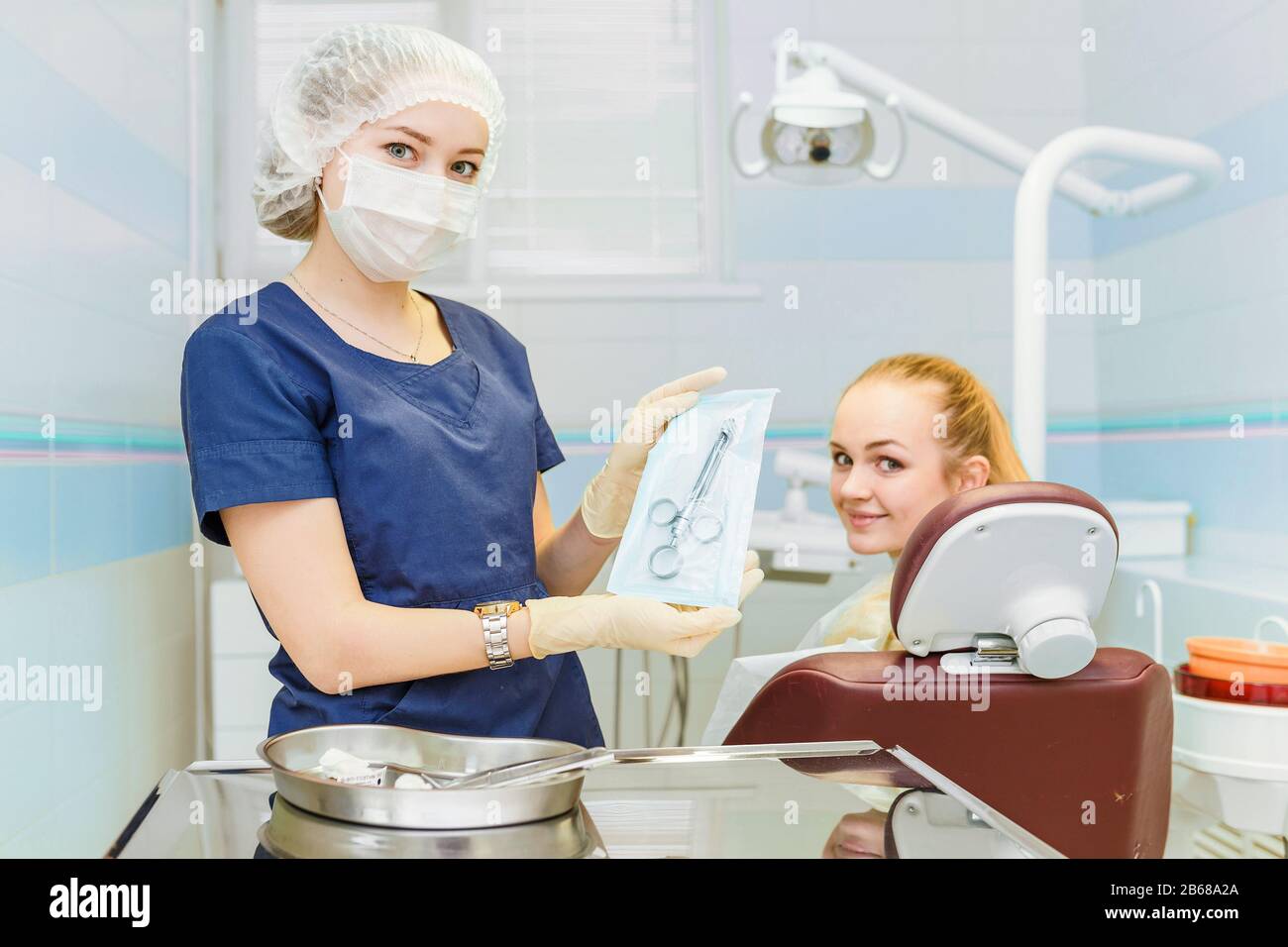 dentist holding a syringe with anesthesia near a chair with a patient
