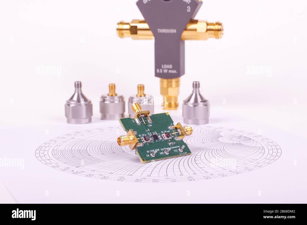Radio frequency mixer printed circuit board in front of Smith chart and