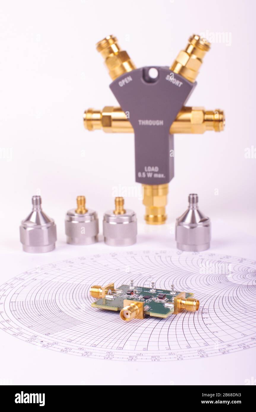 Radio frequency mixer printed circuit board in front of Smith chart and