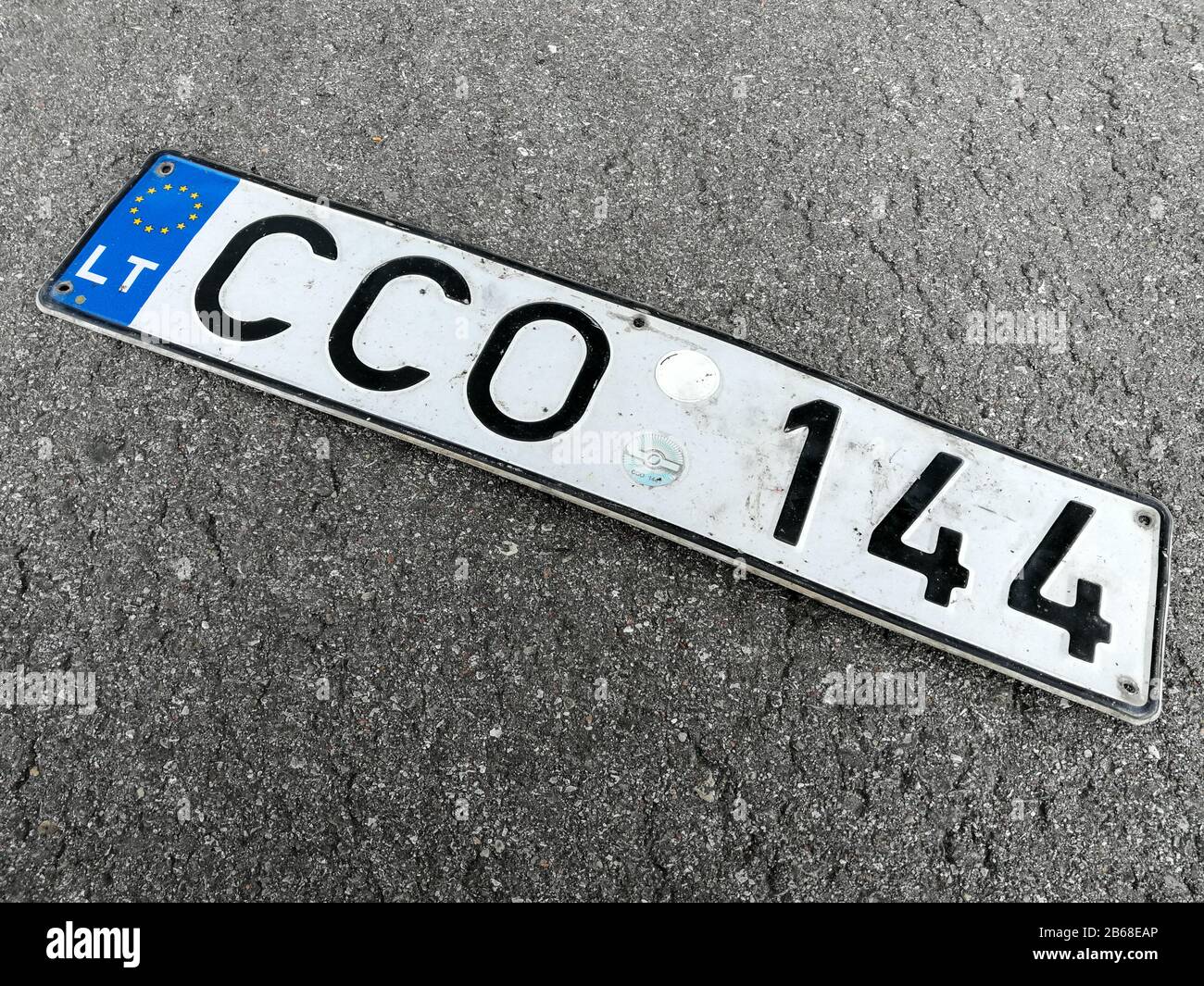 Obsolete lithuanian vehicle registration numbers on the street asphalt Stock Photo