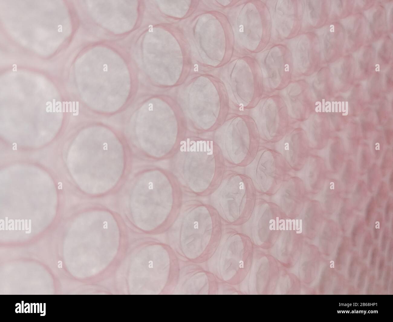 Pink bubble wrap close up for packing fragile things Stock Photo