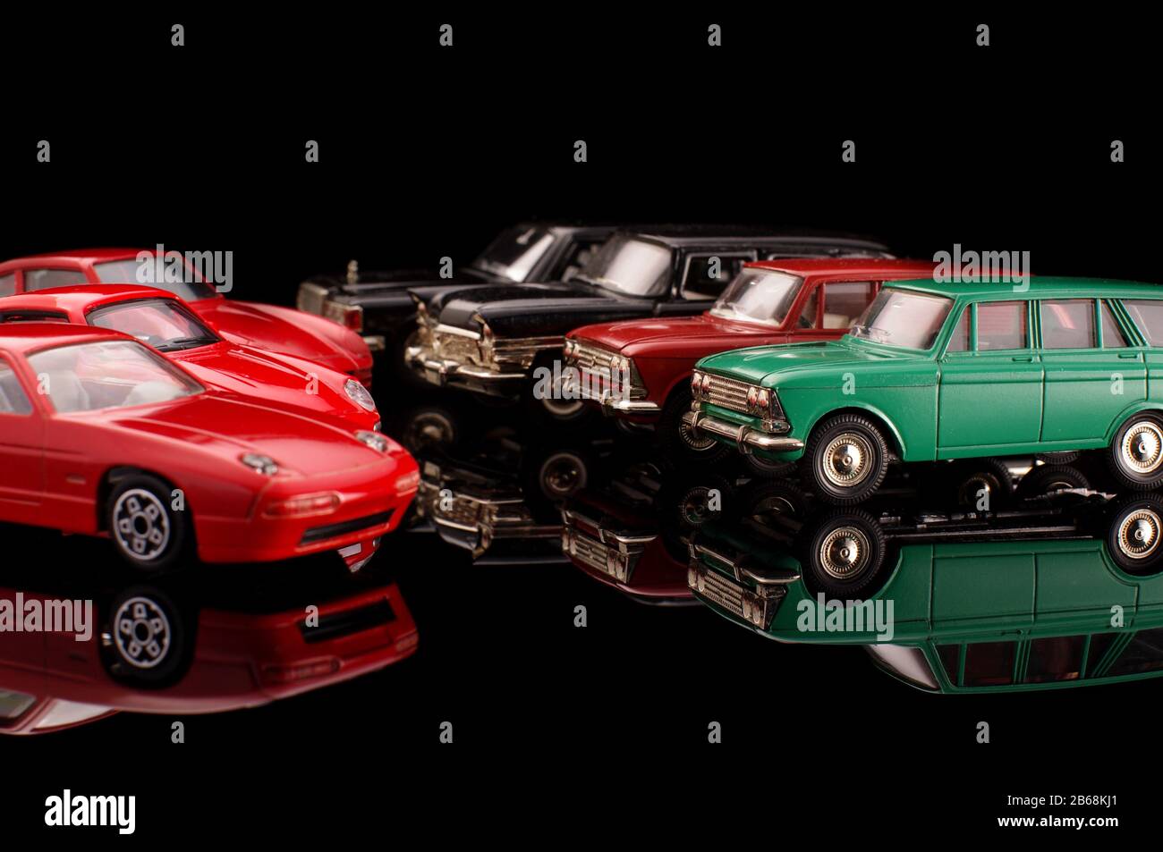 Modern and vintage die-cast car model collections on the black