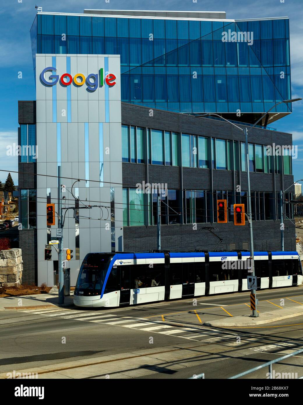 Google Logo Sign and building with LRT train passing. Kitchener Ontario Canada. Stock Photo