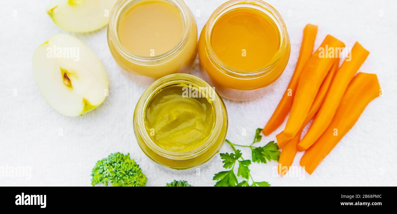 Baby food. Mashed vegetables and fruits in jars. Selective focus ...