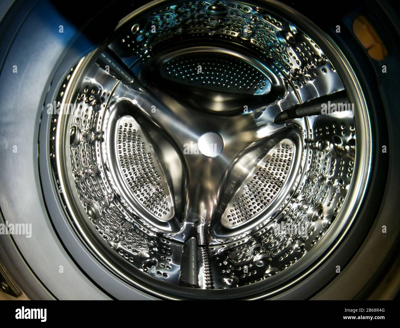 Washing machine drum with many holes internal view Stock Photo Alamy