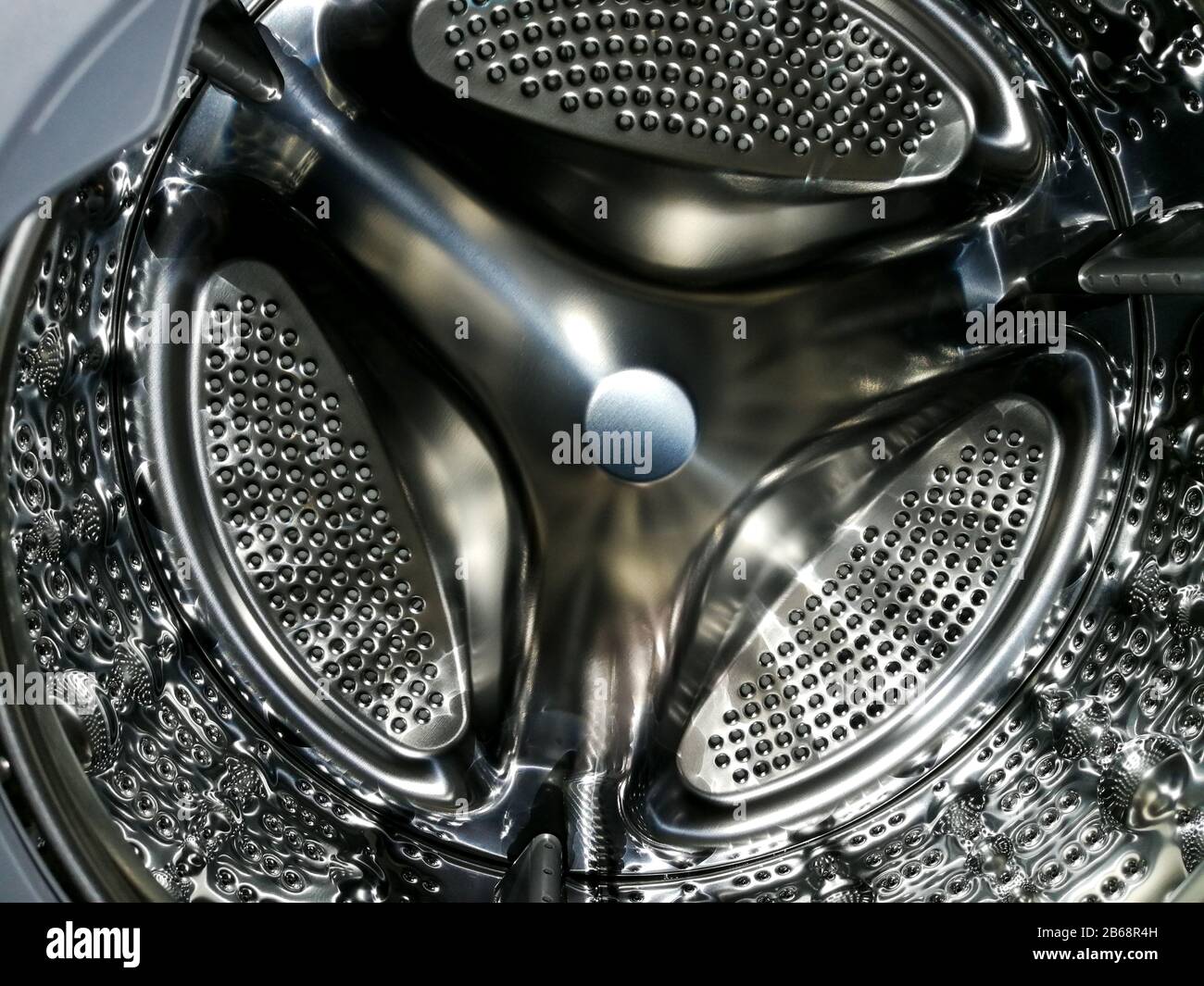 Washing machine drum with many holes internal view Stock Photo Alamy