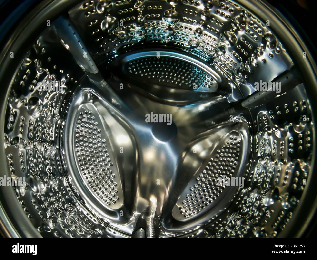 Washing machine drum with many holes internal view Stock Photo Alamy