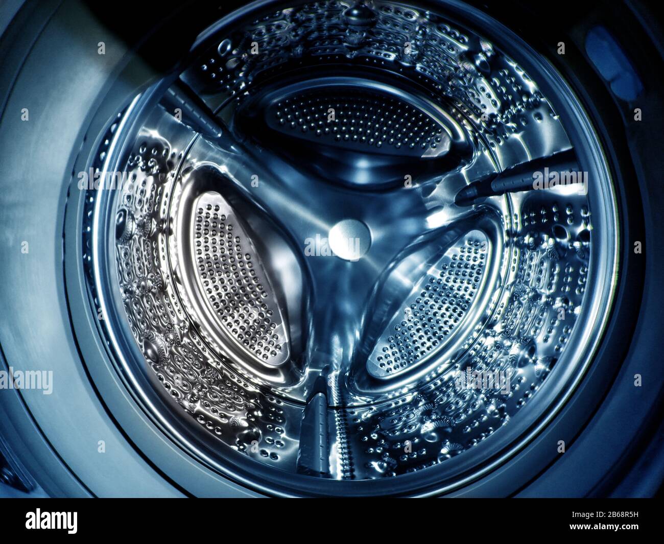 Washing machine drum with many holes internal view Stock Photo Alamy