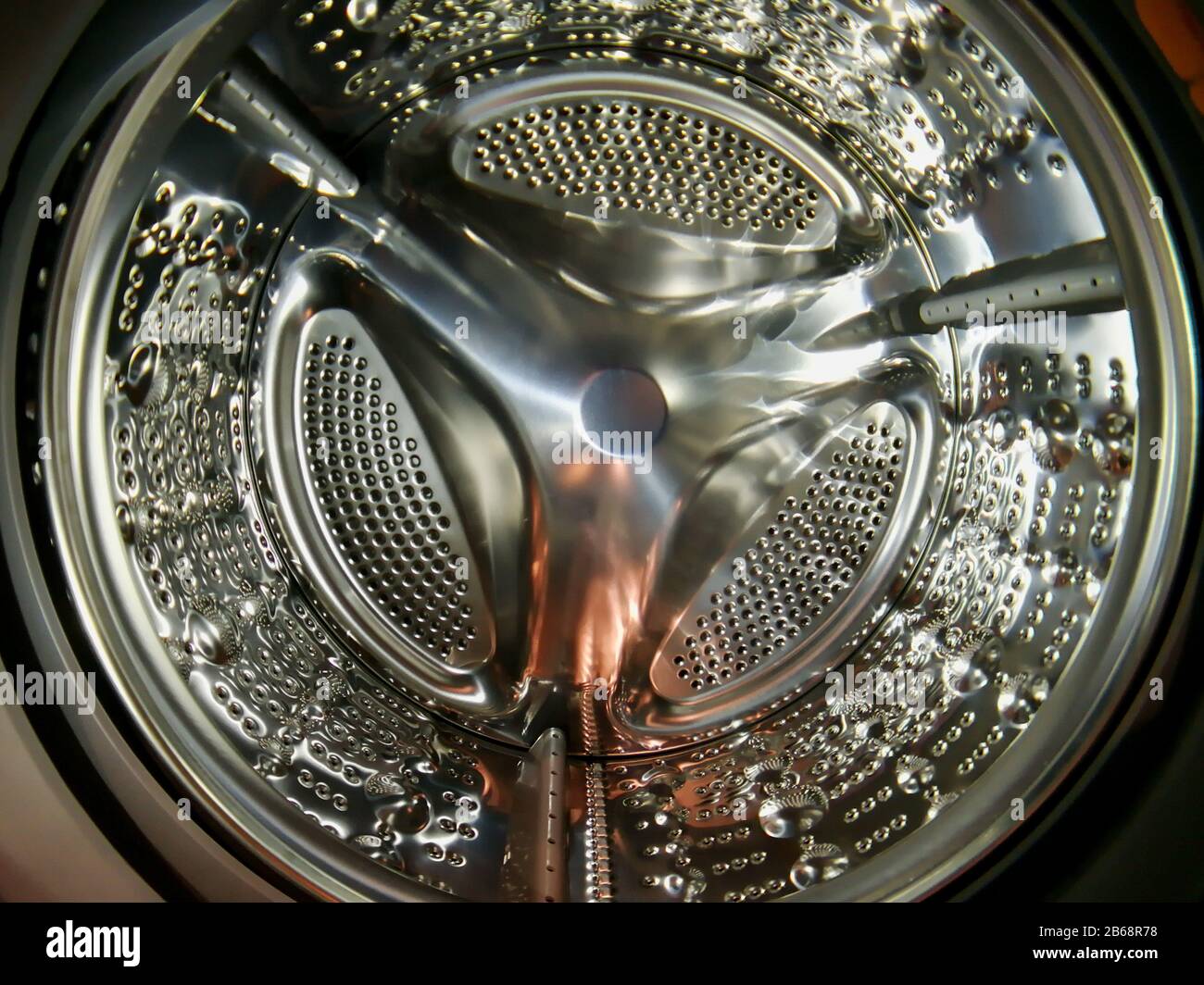 Washing machine drum with many holes internal view Stock Photo Alamy