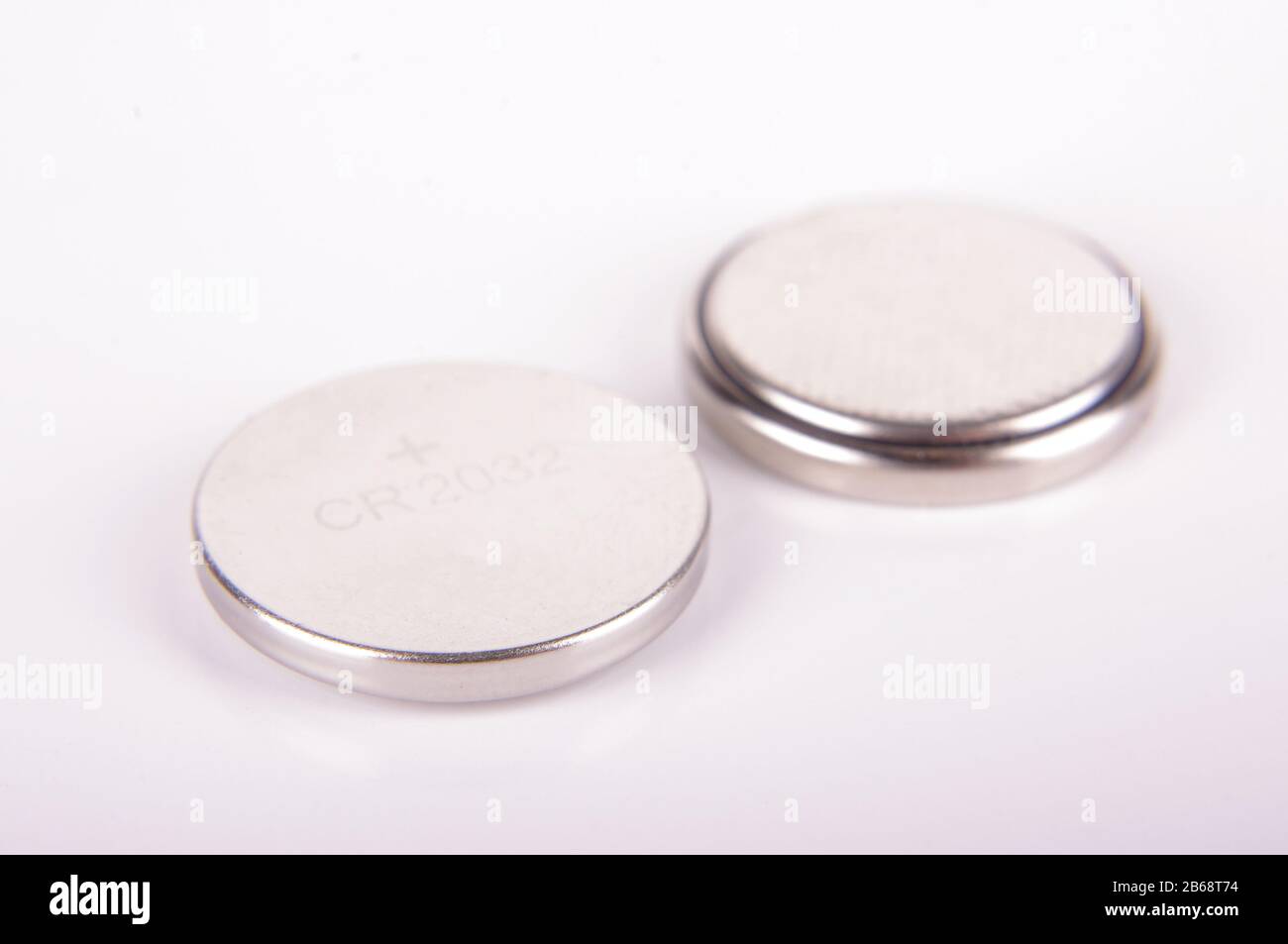 Predictor sum matrix Tiny button cell CR2032 batteries both sides isolated on the white  background Stock Photo - Alamy