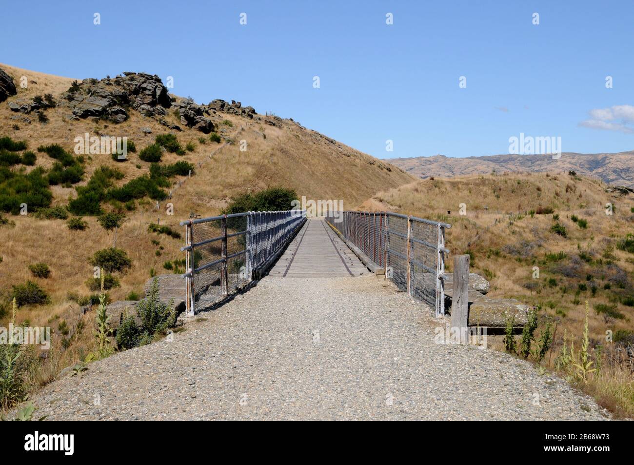 The Central Otago Rail Trail crosses a bridge over a gorge near the township of Lauder. The Trail is a multi day cycle ride or hike. Stock Photo