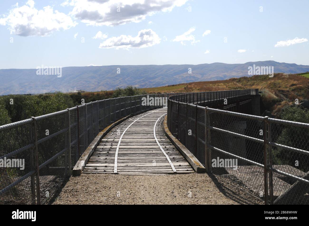 The Central Otago Rail Trail crosses a bridge over a gorge near the township of Lauder. The Trail is a multi day cycle ride or hike. Stock Photo