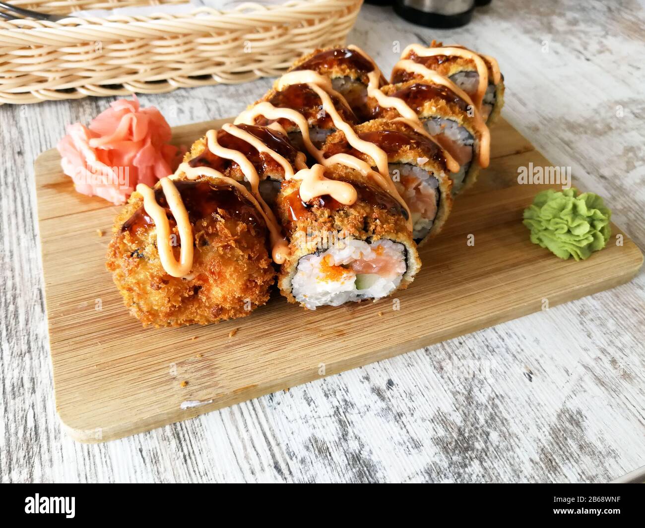 Hot fried sushi rolls with salmon, cheese and avocado serwed with ginger  and wasabi Stock Photo - Alamy