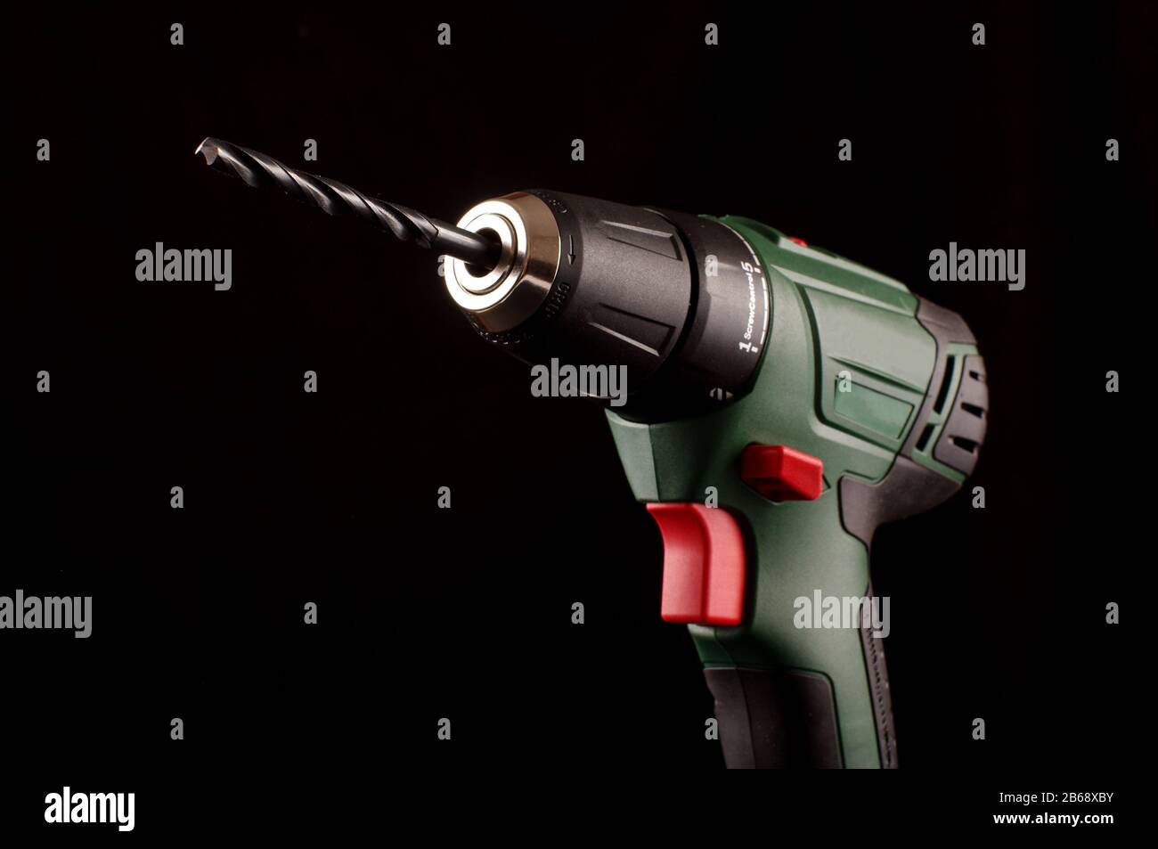 Cordless drill driver isolated on the dark background Stock Photo