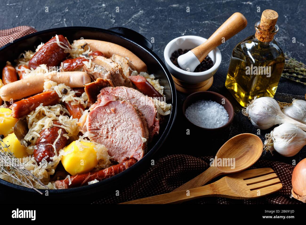 French Alsace region dish choucroute garnie of fermented cabbage with smoked bacon, pork loin, sausages stewed in white wine with onion, garlic and sp Stock Photo