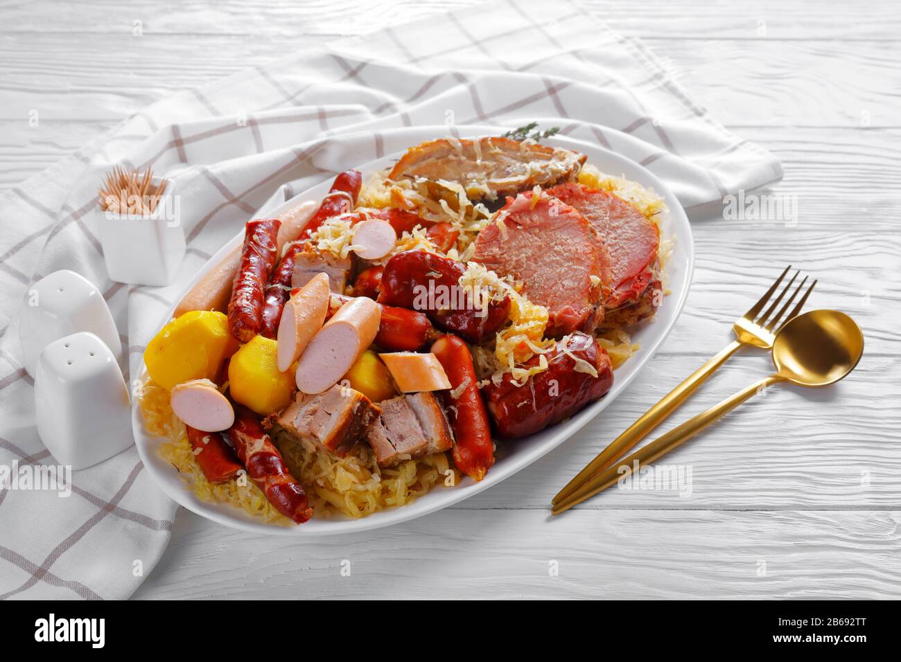 Choucroute garnie french sour cabbage stew with pork meat, smoked