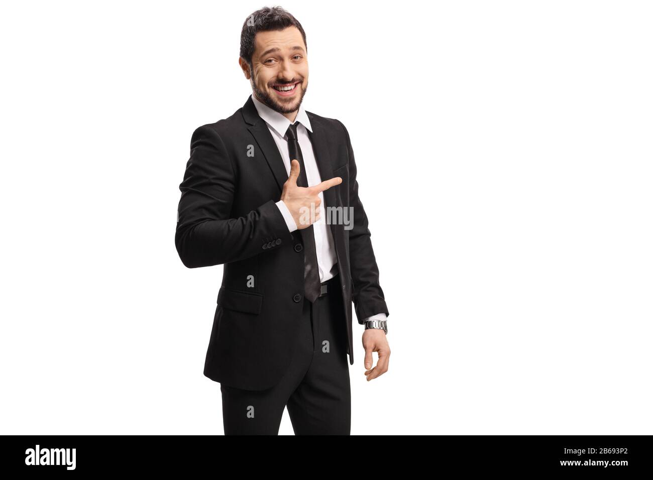 Confident businessman in a suit laughing and pointing isolated on white