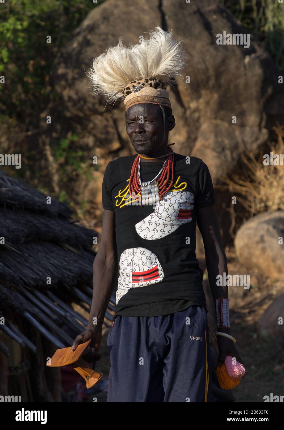 Larim tribe man with a wooden seat during a wedding ceremony, Boya Mountains, Imatong, South Sudan Stock Photo